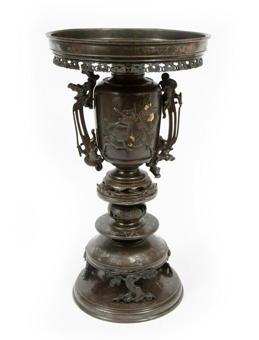 Large Japanese Mixed Metal Usubata: Large Japanese Mixed Metal Usubata, Meiji Period (1868-1912), wide galleried rim, body with recessed scenes of elegant lady before a carriage and warrior astride a horse, multi-tiered base, h.22 1/4 i