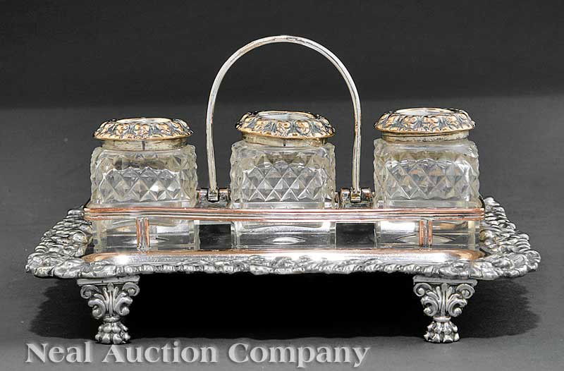Old Sheffield Plate Desk Stand: An Old Sheffield Plate Desk Stand, rectangular tray fitted with three bottles and pen compartments, ornate cast border and winged paw supports, height 4 in., tray 7 5/8 in. x 6 1/8 in