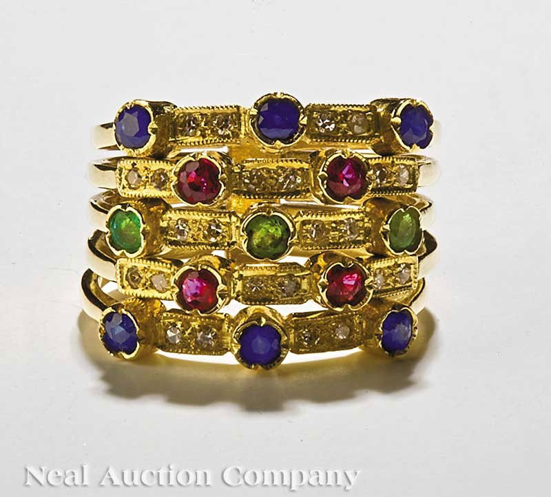 Gold, Sapphire, Ruby, Emerald Diamond Harem Ring: A 14 kt. Gold, Sapphire, Ruby and Emerald Diamond Harem Ring, comprising stacked bands