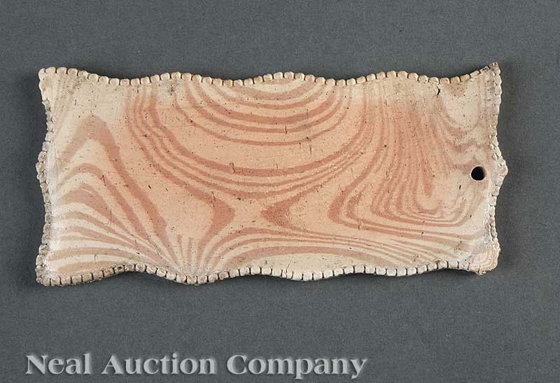 George Ohr Art Pottery "Scrottle" Tile: A George Ohr Art Pottery "Scrottle" Tile, c. 1900, wavy beaded edge, inscribed "Biloxi", 3 in. x 6 1/2 in; together with a 1904 postcard sent from The Biloxi Pottery