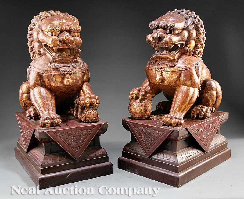 Chinese Painted Wood Buddhist Lions: A Large Pair of Chinese Painted Wood Buddhist Lions, modern, each figure modeled seated on its haunches upon a rectangular plinth, the male with a brocade ball, the female with a cub, each height 29 1