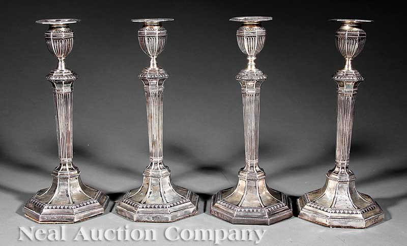 Four English Sterling Silver Candlesticks: A Set of Four English Sterling Silver Candlesticks, maker HF, London, 1915, faceted fluted form with stepped base and beading, weighted base, height 12 1/2 in
