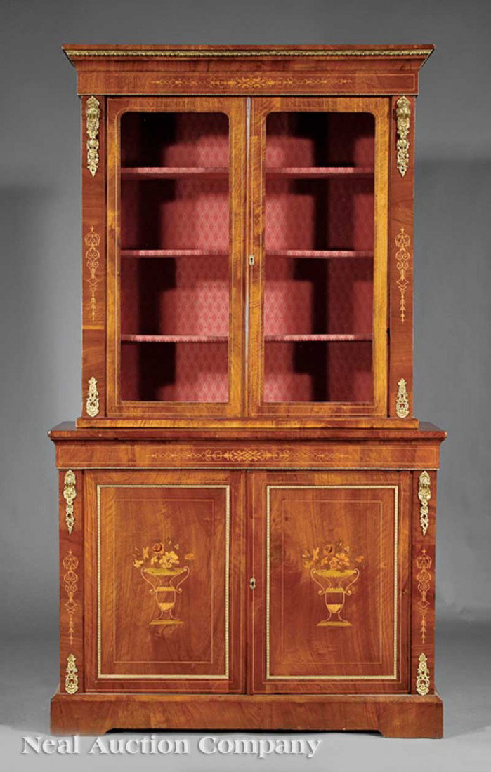 Walnut Marquetry and Ormolu-Mounted Bookcase: An English Walnut Marquetry and Ormolu-Mounted Bookcase, c. 1840, bronze-mounted cornice above a pair of doors, lined interior, base with a pair of urn inlaid doors, blocked base, height 85 in., width