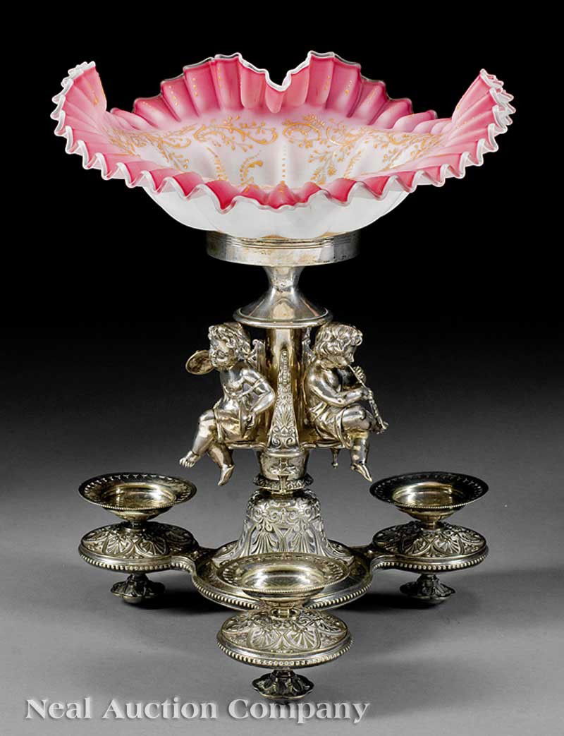 English Silverplate and Art Glass Centerpiece: An English Silverplate and Art Glass Centerpiece, mid-19th c., ruffled bowl in the manner of Thomas Webb; musical putti above faceted tripartite base, registry mark, height 17 1/2 in., width 13 in., d