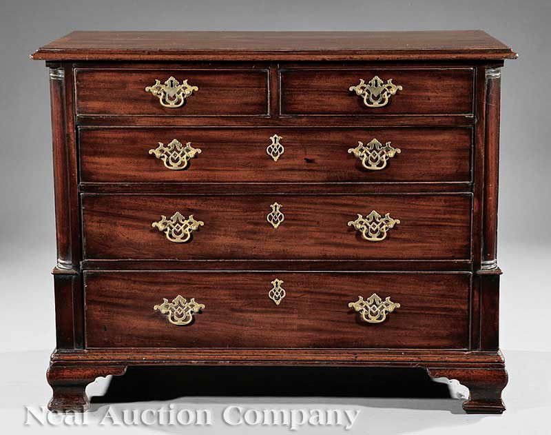 Georgian Carved Mahogany Chest of Drawers: A Georgian Carved Mahogany Chest of Drawers, late 18th c., banded top above two short and three graduated drawers, flanked by engaged columnar stiles, molded base, ogee bracket feet, later brasses, he