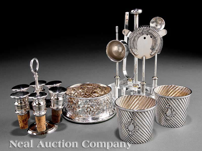 Sterling Silver and Silverplate Bar Items: A Group of Sterling Silver and Silverplate Bar Items, including a vintage motif silverplate wine coaster, silverplate bar tools on stand, silverplate mounted corks on stand; together with a pair of si