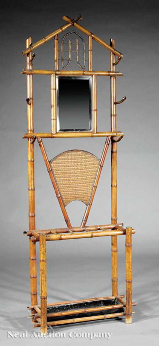 Faux Bamboo Hall Stand: An Antique Faux Bamboo Hall Stand, c. 1900, crest and stiles with hat hooks, mirrored frieze, woven fan panel, umbrella slots, drip pan, height 83 1/4 in., width 29 1/2 in., depth 12 in