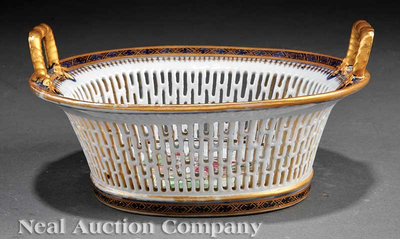 Chinese Export Famille Rose Porcelain Basket: A Chinese Export Famille Rose Decorated Blue and White Porcelain Basket, 18th/19th c., reticulated oval body with flared rim applied with upright flange handles, enameled to the well with children pla