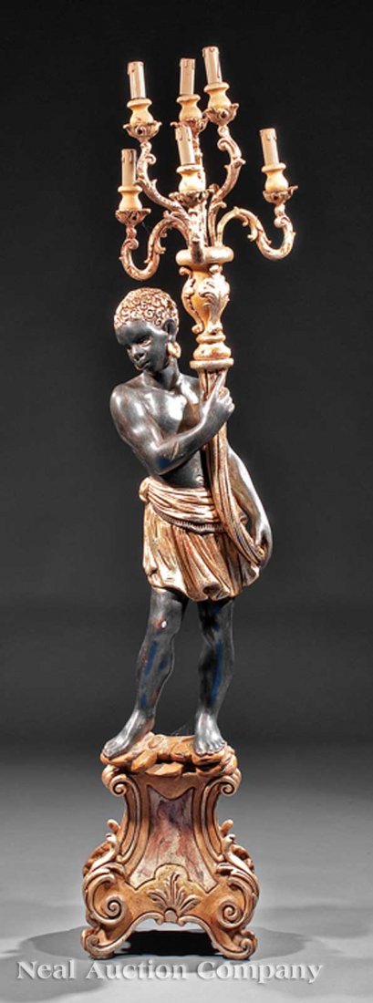 Gilt and Paint-Decorated Blackamoor Candelabrum: A Decorative Gilt and Paint-Decorated Blackamoor Candelabrum, on a rococo-style gilt base, height 70 in. width 13 1/2 in., depth 10 in. Provenance: Nick McKinney