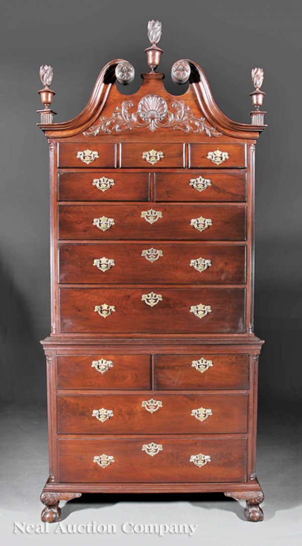 Chippendale Carved Mahogany Chest-on-Chest: An Antique American Chippendale Carved Mahogany Chest-on-Chest, the upper case with broken arch crest, flame finials, shell and foliate carved frieze above a configuration of graduated drawers, fluted