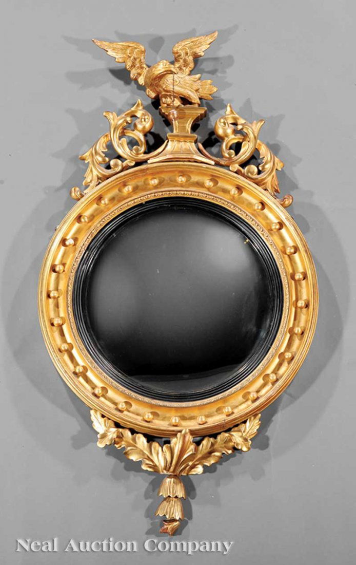 Carved Giltwood Convex Mirror: An American or English Carved Giltwood Convex Mirror, 19th c., eagle and leaf crest, circular frame with spherules, ebonized rabbet, leaf carved pendant, height 46 1/2 in., width 25 1/2 in