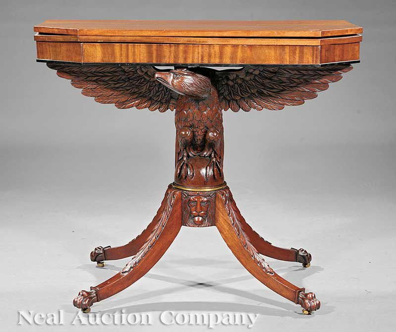 American Carved Mahogany Games Table: An American Carved Mahogany Games Table, after Duncan Phyfe, top with canted corners above a conforming apron, distinctive spread wing American eagle support on domed plinth, acanthus carved sabre leg