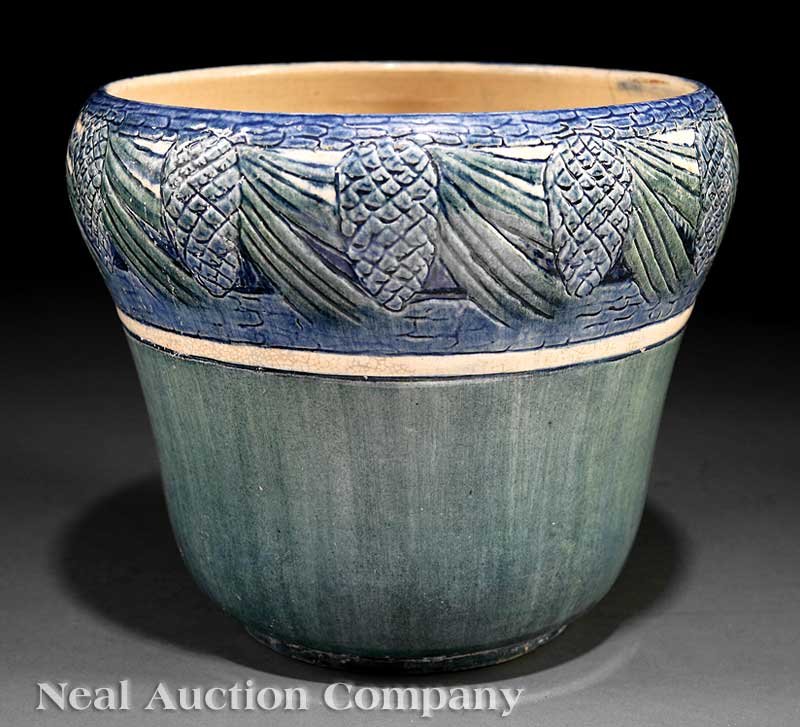 Newcomb College Art Pottery High Glaze Jardiniere: A Newcomb College Art Pottery High Glaze Jardiniere, 1907, decorated by Marie de Hoa LeBlanc with a relief carved pine needle and cone motif, the base marked with Newcomb cipher, decorator's mark, Jos