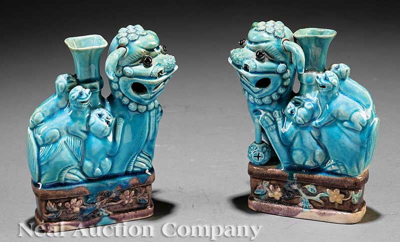 Chinese Glazed Buddhist Lion Joss Stick Holders: A Pair of Chinese Turquoise Blue, Aubergine and Biscuit Glazed Buddhist Lion Joss Stick Holders, 17th/18th c., each lion-dog modeled seated on a rectangular floral molded plinth with baby pups clamber