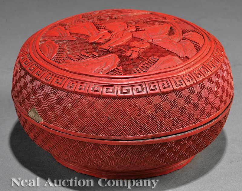 Chinese Cinnabar Lacquer Circular Box and Cover: A Chinese Cinnabar Lacquer Circular Box and Cover, Qing Dynasty (1644-1911), globular body raised on a circular foot ring, the domed cover with a central roundel enclosing three figures beneath a tree