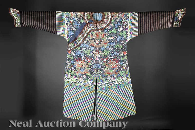 Chinese Blue Ground Kesi Dragon Robe, Jifu: A Chinese Blue Ground Kesi Dragon Robe, Jifu, Qing Dynasty (1644-1911), woven in slit-weave technique with nine golden dragons on a blue ground amid ruyi clouds, bats and the bajixiang, above a terres