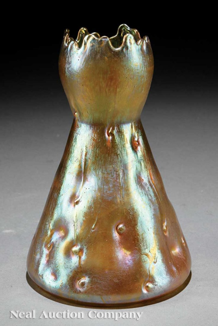 Loetz Astartig Iridescent Glass Vase: A Loetz Astartig Iridescent Glass Vase, c. 1900, of golden color and high-waisted shape, with pulled rim and characteristic dimples with protrusions throughout, height 8 in., diameter 5 1/4 in
