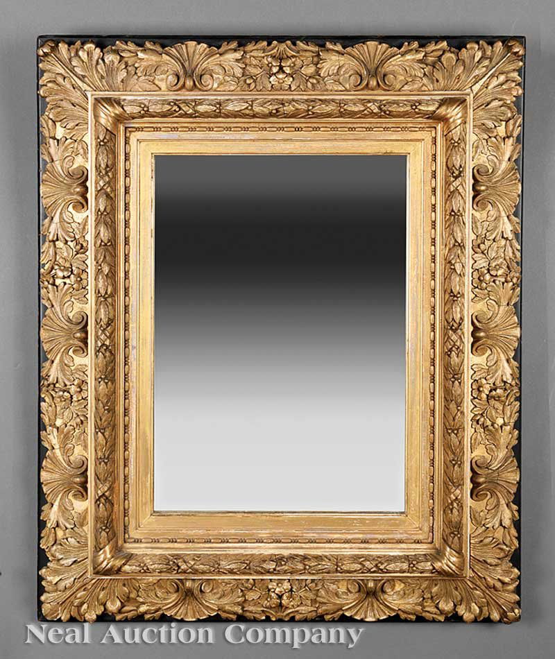 American or English Carved and Gilded Mirror: An Antique American or English Carved and Gilded Mirror, 19th c., in the Rococo taste, ebonized backboard, shell and floral surround, laurel and bead inner frame, later mirror plate, height 32 1/4 in.