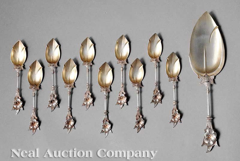 George Sharp Coin Silver Ice Cream Set: An American Coin Silver Ice Cream Set, George Sharp, Philadelphia, wc. 1844-1874, including an ice cream spade and 10 ice cream spoons, each with floral and foliate handle, retaining traces of origina