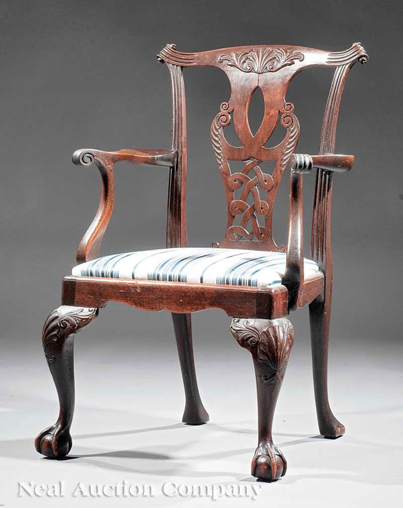 Carved Mahogany Armchair: An Irish Chippendale-Style Carved Mahogany Armchair, 19th c. and later, foliate shell crest rail, reticulated splat, scrolled arms, cabriole legs ending in claw and ball feet. Provenance: B. Manheim,