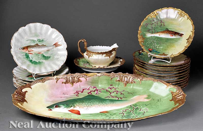 Limoges Gilt, Polychrome Porcelain Fish Service: A French Gilt and Polychrome Porcelain Fish Service, c. 1900, Limoges, France, consisting of a platter, 12 plates and one sauceboat with undertray (note: loss), each with fish reserve, signed Dupont, 