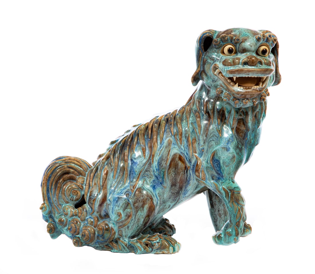 Chinese Shiwan Glazed Pottery Buddhist Lion: Chinese Shiwan Glazed Pottery Buddhist Lion, 19th/20th c., overall mottled blue and brown glaze, bisque eyes, teeth and toung, base inscribed, h. 11 1/4 in., w. 11 in., d. 4 3/4 in. Provenance: Estate