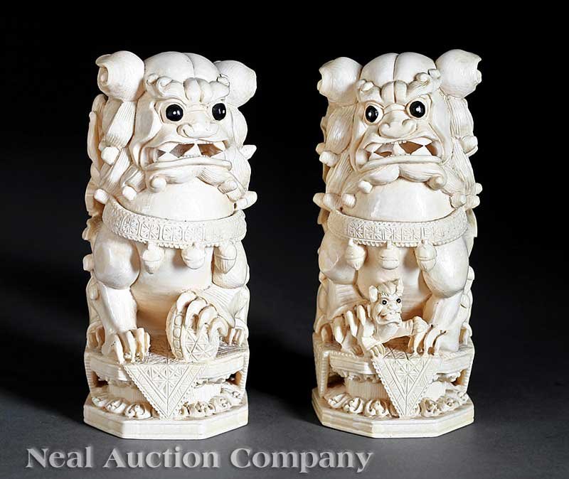 Pair of Chinese Ivory Buddhist Lions: A Pair of Chinese Ivory Buddhist Lions, each carved seated on a waisted pedestal with a pup clambering up its backside, height 5 1/4 in Provenance: Estate of Margaret Winling Gulotta (1928-2007), New 