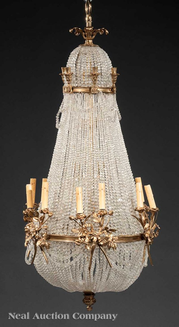 French Dore Bronze and Crystal Chandelier: A French Louis XVI-Style Dore Bronze and Crystal 12-Light Chandelier, height 50 in., diameter 22 1/2 in