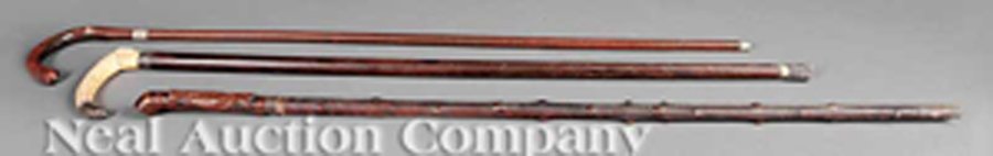 Group of Three Canes: A Group of Three Canes, 19th c., including a sword cane with carved wood handle depicting gun and game bag; a Japanese red and black lacquered cane; and one with a carved tusk handle with sterling tip