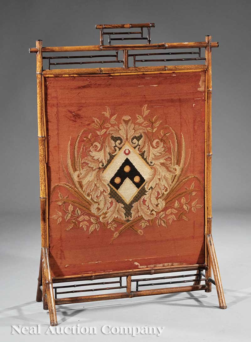 English Bamboo and Needlepoint Firescreen: An Antique English Bamboo and Needlepoint Firescreen, late 19th c., reticulated design, inset needlepoint with coat-of-arms, outswept legs, height 45 1/2 in., width 30 in