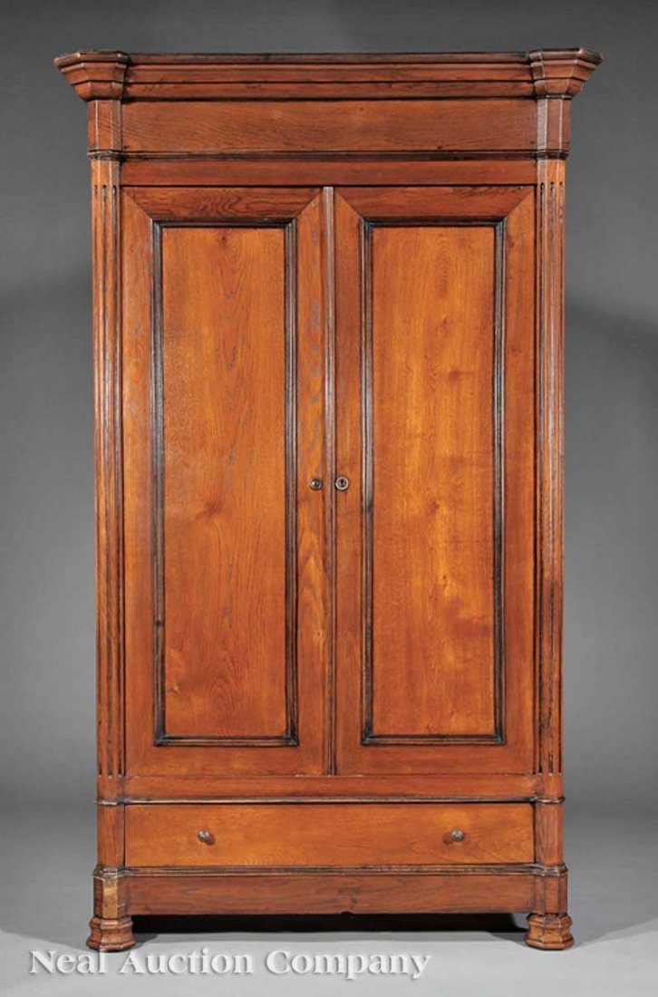 French Carved Pine Armoire: A French Carved Oak Armoire, 19th c., molded cornice, pair of paneled doors flanked by engaged fluted columns, drawer below, blocked octagonal feet, height 88 1/4 in., width 53 in., depth 23 in