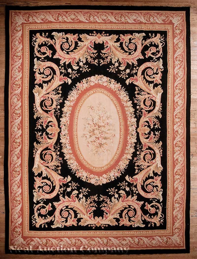 Aubusson Carpet: An Aubusson Carpet, black ground with cream and salmon central medallion, 10 ft. x 14 ft