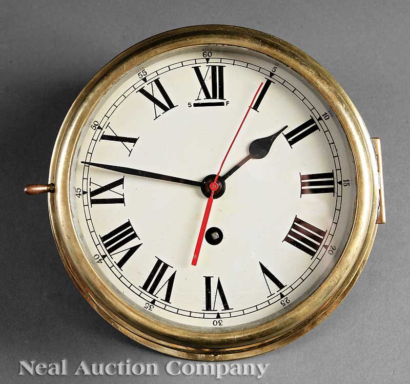 English Brass and Nickel-Plated Ship's Clock: An English Brass and Nickel-Plated Ship's Clock, c. 1930, with sweeping second hand, base with screws for wall mounting, diameter 8 in