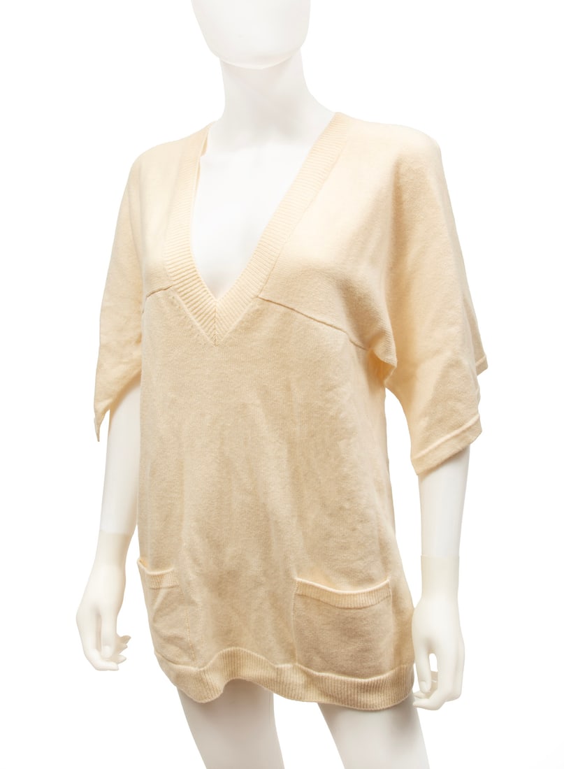 Chanel 2012 Runway Resort Ivory Cashmere Tunic: Chanel 2012 Runway Resort Ivory Cashmere Tunic, 2012, Look 13, crystal embellished logo button on back, labeled "CHANEL" and "Made in Italy", tag numbered "PK42913K04371" and "AW005", size 38. Conditi