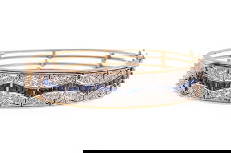 14 kt. Gold, Sapphire, Diamond Bangle Bracelet: 14 kt. Yellow Gold, Blue Sapphire and Diamond Hinged Bangle Bracelet, set with numerous full cut diamonds and invisibly set sapphires, marked "JP", inner circ. 6 1/4 in., 17.23 dwts.