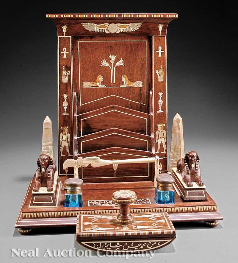 Bone, Mother-of-Pearl Inlaid Rosewood Desk Stand: An Egyptian Revival Bone and Mother-of-Pearl Inlaid Rosewood Desk Stand, c. 1900, pylon form letter rack flanked by obelisks and sphinxes, with two cut glass inkwells, a rocker blotter and a letter op