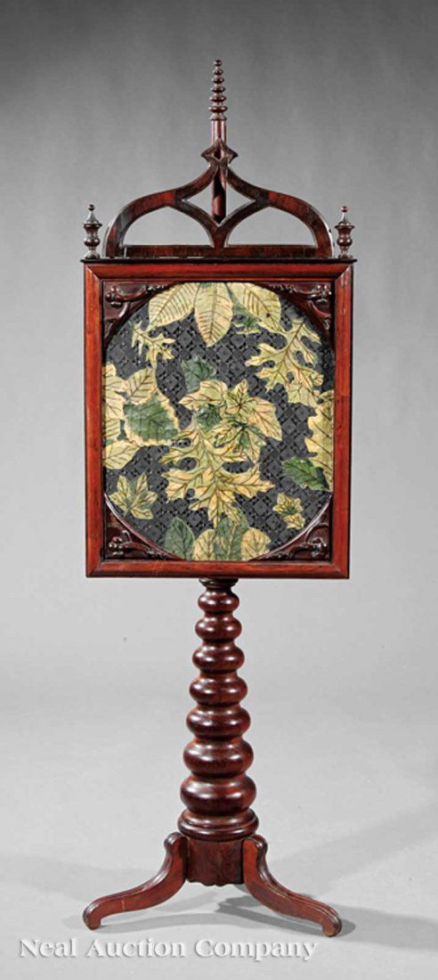 American Gothic Carved Rosewood Pole Screen: An American Gothic Carved Rosewood Pole Screen, c. 1850, cathedral crested frame enclosing an upholstered panel, graduated ring-turned support, three splayed legs, height 55 in., width 17 in., depth 1