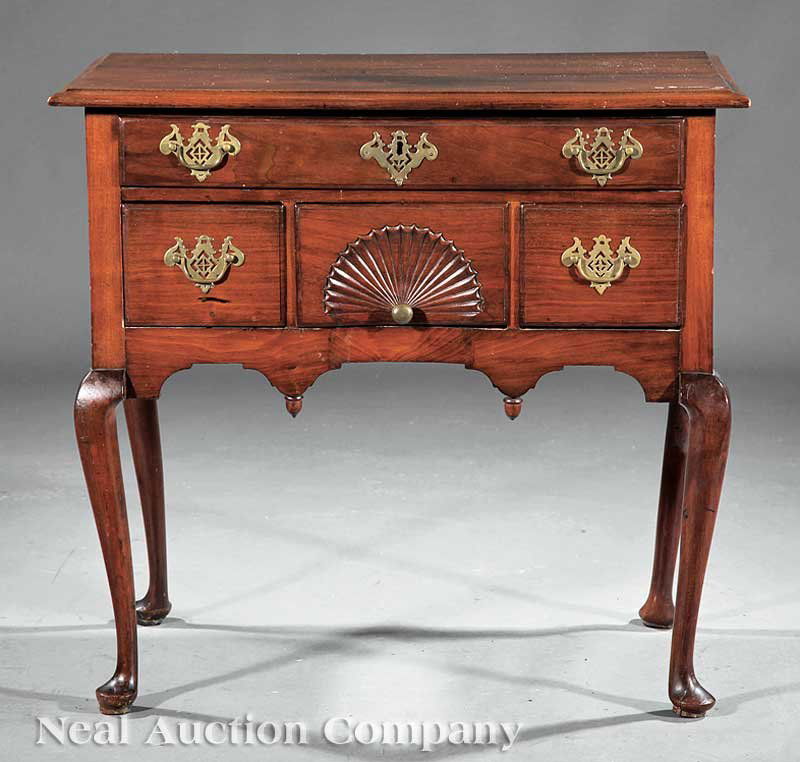 American Queen Anne Carved Mahogany Lowboy: An Antique American Queen Anne Carved Mahogany Lowboy, New England, molded top above a long drawer, shell carved drawer flanked by short drawers, acorn pendants, cabriole legs, pad feet, height 30 in.