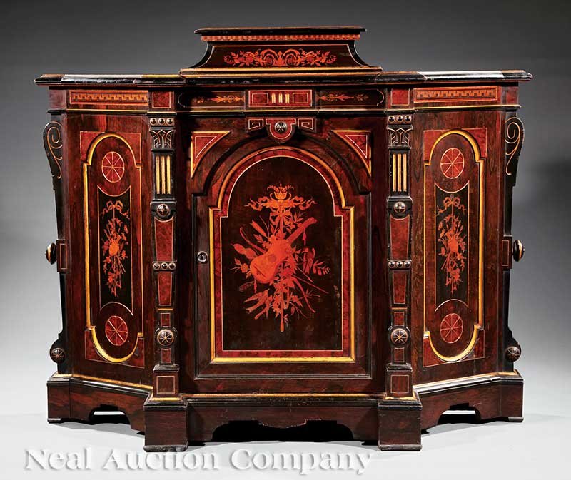 Carved, Gilded, Ebonized, Rosewood Parlor Cabinet: An American Neo-Grec Carved, Gilded, Ebonized and Inlaid Rosewood Parlor Cabinet, mid-19th c., New York, shaped top with a raised plinth centered by an exotic wood inlaid frieze, door with musical tro