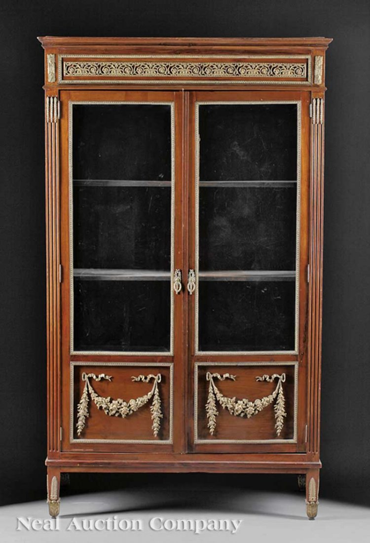 Carved Mahogany, Gilt Bronze-Mounted Bibliothèque: A Louis XVI-Style Carved Mahogany and Gilt Bronze-Mounted Bibliothèque, 19th c., molded cornice over a pair of glazed doors, shelf interior, paneled sides, square tapered legs, height 73 in., width 4