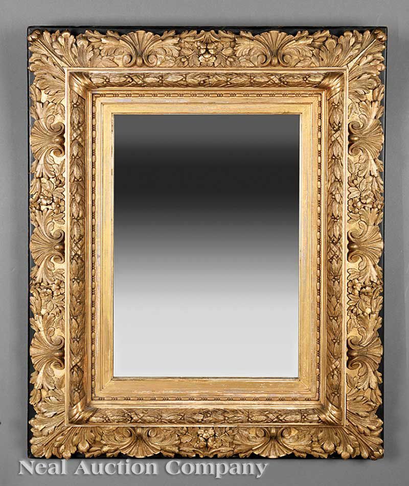 American or English Carved and Gilded Mirror: An Antique American or English Carved and Gilded Mirror, 19th c., in the Rococo taste, ebonized backboard, shell and floral surround, laurel and bead inner frame, later mirror plate, height 32 1/4 in.