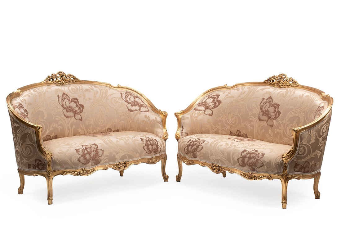 Pair of Louis XV-Style Carved Giltwood Settees: Pair of Louis XV-Style Carved Giltwood Settees, reticulated floral crest, scrolled crest rail, serpentine seat rail, cabriole legs, scrolled toes, h. 39 in., w. 62 1/2 in., d. 29 in.