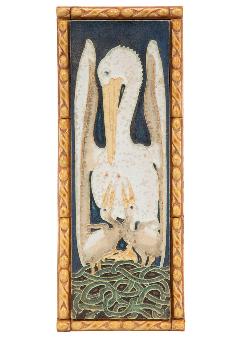 De Porcelyne Fles Tile of a Pelican: De Porcelyne Fles Tile of a Pelican Feeding Its Young, c. 1900, in white and beige cuenca on dark indigo ground, mounted on board with amber border tiles, probable mark hidden by board, 13 1/2 in. x 5