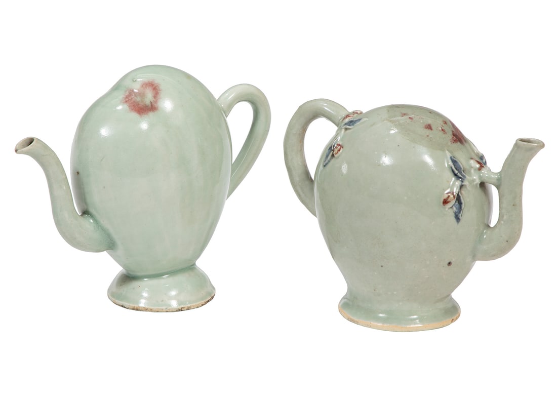 Two Chinese Celadon Porcelain Wine or Teapots: Two Chinese Celadon Porcelain "Cadogan" or "Puzzle" Wine Pots or Teapots, each of peach-form, taller with small copper red, peachbloom glazed spot at top, h. 6 1/4 in., w. 8 in.; shorter with molded c