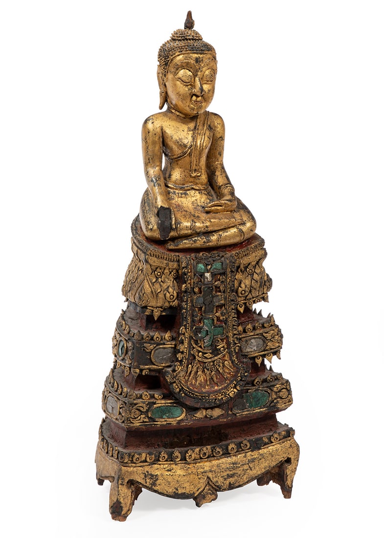 Antique Burmese Carved and Gilded Wood Buddha: Antique Burmese Carved and Gilded Wood Figure of Buddha, modeled seated on colored glass gem embellished, painted, an carved tiered wood stand, h. 22 1/2 in., w. 9 1/4 in., d. 6 1/4 in. Provenance: Re