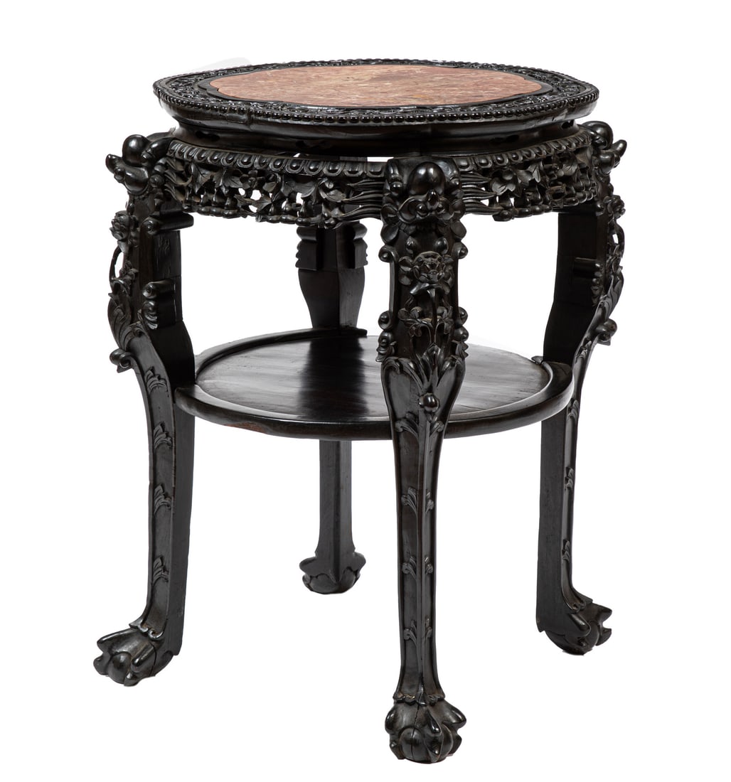Chinese Hardwood Table: Chinese Hardwood Table, early 20th c., waisted petal-lobed top inset with pink marble, reticulated apron carved with foliage, medial shelf, tall lions mask legs carved with foliage and terminated in c