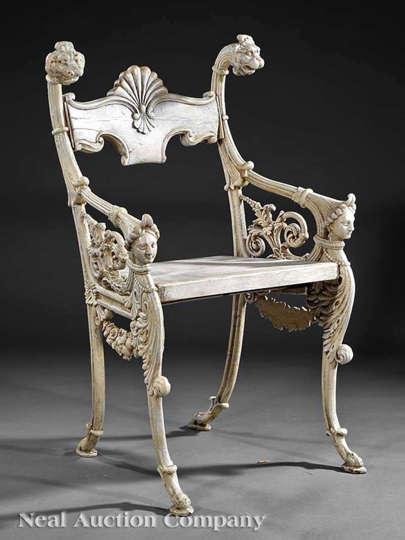 English Cast Iron Garden Chair: An English Cast Iron Garden Chair, 19th c., fan-carved wood crest rail, lion's mask stiles, arms terminating in female busts, trapezoidal plank seat, foliate scroll legs ending in padded paw feet