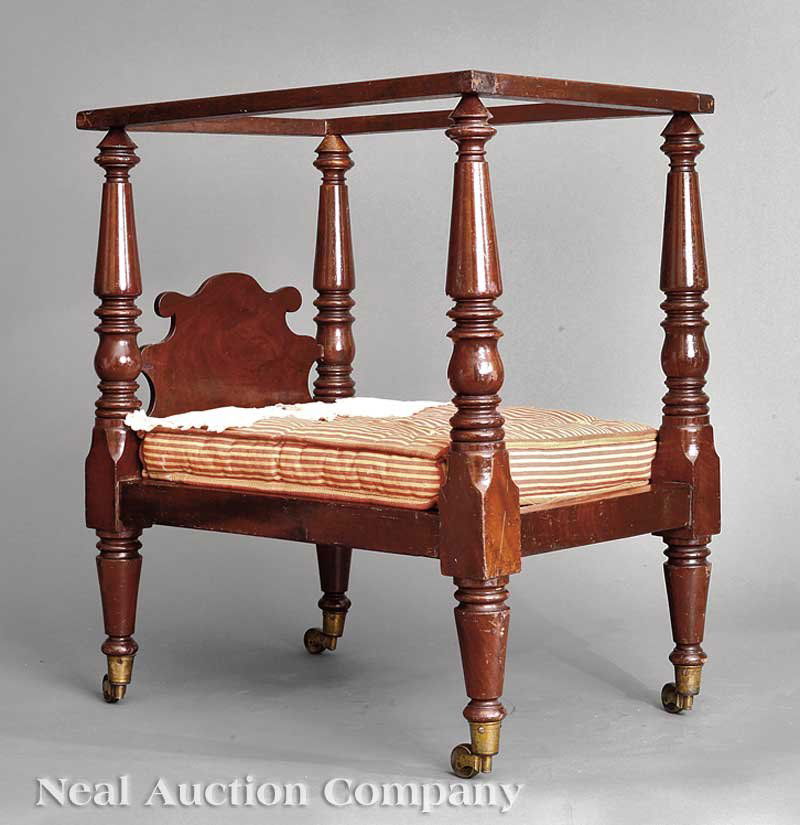American Carved Mahogany Miniature Tester Bed: A Fine and Rare American Carved Mahogany Miniature Tester Bed, 19th c., probably Louisiana, flat tester, ring and baluster-turned posts, shaped headboard, brass ferrules and casters, height 23 3/4 in.