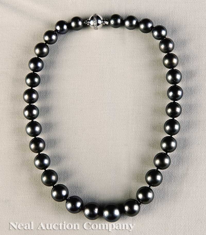A Black Tahitian Pearl Necklace: A Black Tahitian Pearl Necklace, containing 35 pearls graduated from 11.0 mm. to 15.0 mm., with 14 kt. white gold ball clasp with band of single cut diamonds