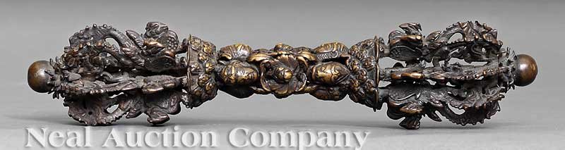 A Tibetan Bronze and Iron Vajra: A Tibetan Bronze and Iron Vajra, probably 18th/19th c., central grip modeled with mask heads and foliage, the points comprised of multiple dragon and phoenix prongs terminating in balls, length 10 1/4